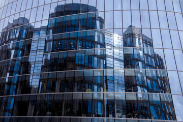 Fototapeta na wymiar Mirror high blue Skyscraper. Modern high-rise building made of glass.