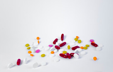 Assorted pharmaceutical medicine pills, tablets and capsules.Pills background. Heap of assorted various medicine tablets and pills different colors on white background. Health care.Top view.Copy space