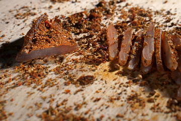 Close up of cuts dried pieces of meat. Tasty dried chicken chips are ready to eat