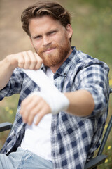 a man doing his bandaged outdoors