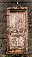 Old weathered wooden door on abandoned cabin