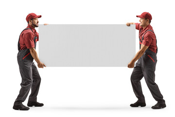 Full length shot of two male workers carrying a blank panel board