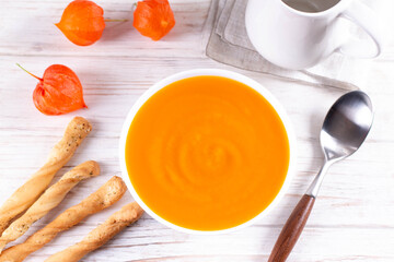 Healthy comfort pumpkin, butternut squash soup in white bowl. Autumn Winter food
