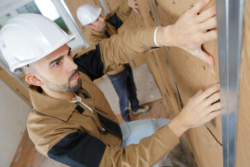 portrait of builders soundproofing and insulation