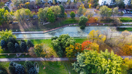 Top view of autumn city european park with yellow and green trees