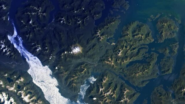 Scenic sunrise on green islands archipelago aerial satellite view at Moraleda channel, Chile. Based on image furnished by Nasa