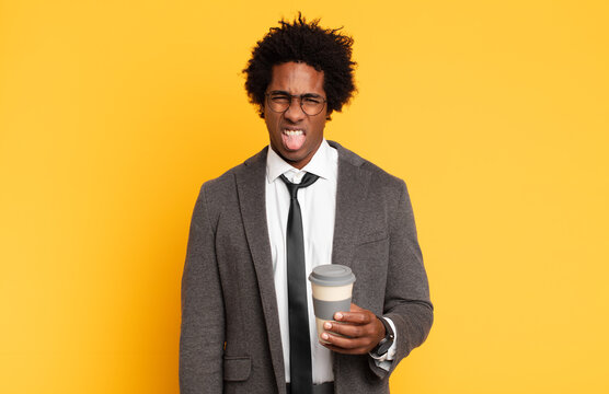 young black afro man feeling disgusted and irritated, sticking tongue out, disliking something nasty and yucky
