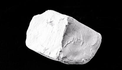 Kaolin on isolated black background, is an inorganic mineral, chemically inert