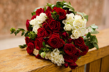 Wedding bouquet of red and white roses. Beautiful bridal bouquet close up. Wedding accessories