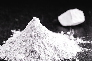 Kaolin on isolated black background, is an inorganic mineral, chemically inert, used in several branches of industry, from cosmetics to dye