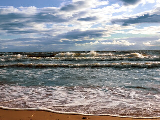 Autumn storm on the Baltic Sea. Waves run down the sandy beach