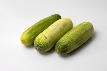 Fresh green cucumbers on white background