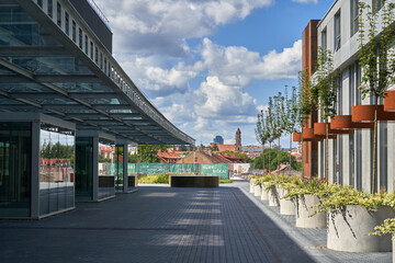 Obraz premium Avenue in the city. Old town roofs and towers in the background. 