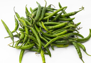 Fresh organic green chilli peppers on white background