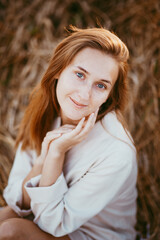 portrait of a girl of model appearance in wheat, a girl sitting on a wheat field