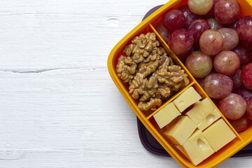 Food in Plastic containers ready to eat with Cheese, grapes and nuts