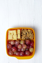 Food in Plastic containers ready to eat with Cheese, grapes and nuts