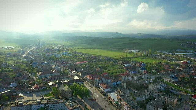 Huedin,Cluj/Romania-04.30.2020-Aerial view over Huedin city centre. You can see the city hall, house of culture, Public finances administration, Vladeasa hotel, Reformed Church and DN1E60 road