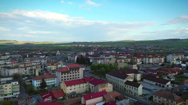 Huedin,Cluj/Romania-04.30.2020-Aerial view over Huedin city centre. You can see the city hall, house of culture, Public finances administration, Vladeasa hotel, Reformed Church and DN1E60 road