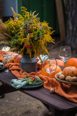 Fall themed holiday table setting arrangement for a seasonal party