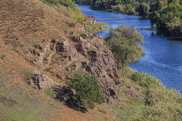 Riverbank with rocks on a sunny day