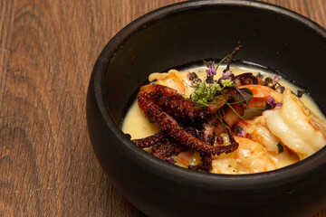 Shrimp and Octopus Casserole with Honey and Flowers Sauce.