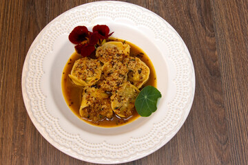 Oxtail tortelli and crispy onion farofa.