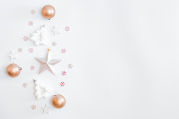 Flat lay border with christmas balls, stars and snowflakes on a white background