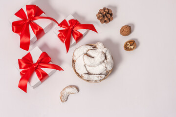 Traditional Austrian and German crescent-shaped Christmas pastries - Vanillekipferl - on a white table with Christmas decorations