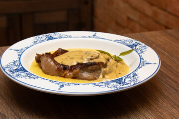 Entrecot with funghi sauce and creamy polenta.