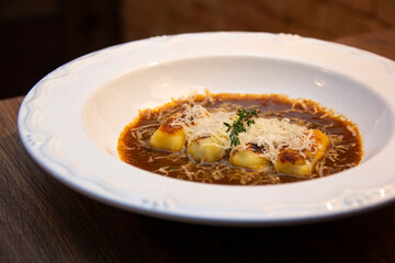 Gnocchi stuffed with ossobuco, ossobuco broth and grana padano cheese