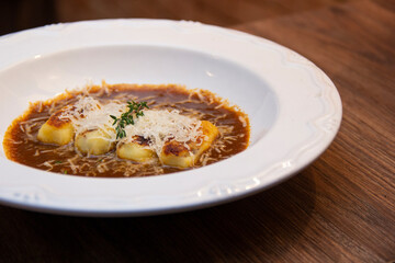 Gnocchi stuffed with ossobuco, ossobuco broth and grana padano cheese