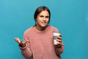 young hispanic woman looking angry, annoyed and frustrated screaming wtf or what’s wrong with you