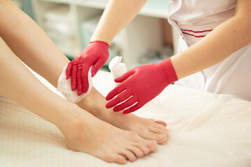Fototapeta na wymiar Sugaring and body peeling beauty salon red rubber gloves