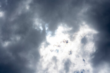unusual storm clouds hide the summer sun in their thickness