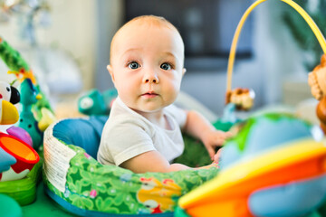 Obraz premium little baby playing with toys at home in the living room