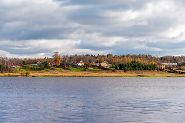 Obraz premium Rural landscape with village and river in the autumn