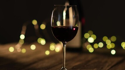 glass of red wine on a wooden restaurant table slow movement