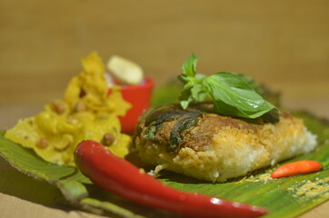 Baked Rice or Nasi Bakar / Nasi Lemak food product on wooden texture background