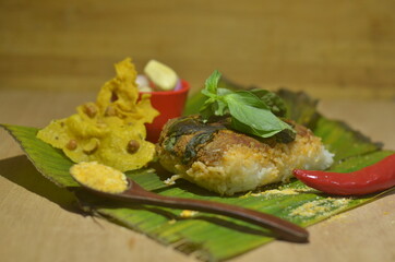 Baked Rice or Nasi Bakar / Nasi Lemak food product on wooden texture background