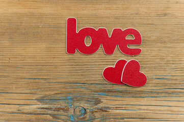 Valentine concept. Inscription Love You with hearts on wooden table background. Top view