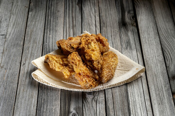 Delicious barbecue chicken wings, on a rustic wooden background.