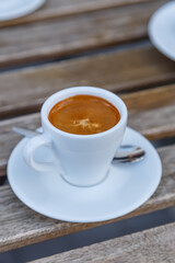 Cup of coffee on table in coffee shop cafe.A cup of coffee and coffee beans with croissant on the table