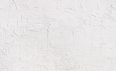 Stucco wall texture. Grainy and  fractured wall surface with fine details. White wall background.