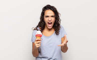 young hispanic woman looking angry, annoyed and frustrated screaming wtf or what’s wrong with you