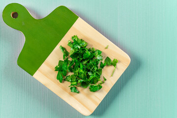 Chopped parsley on cutting board. Copy space for text.