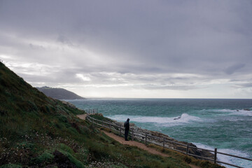 Fototapeta na wymiar A Coruña, coast of Spain during a rain with a man looking to the sea