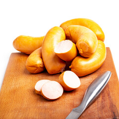 Shooting in the studio. Meat products, semi-finished products. sausage pork sausages on a wooden tray. Close-up.