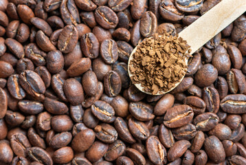 Top view of instant coffee and roasted coffee beans, close-up.
