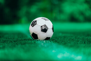 Black and white soccer ball in the field. Vintage color filter
